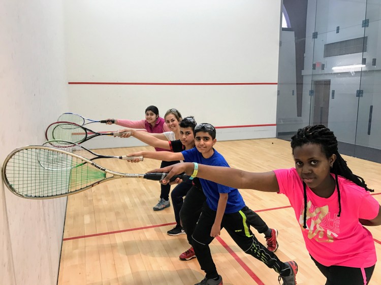 At Portland Community Squash on Noyes Street, coach Marilu Fortson, second from left, works with students, from left, Fatima Al-Bayati, Ahmed Albadri, Yousif Ali, and Auxane Bahunde Iriza.