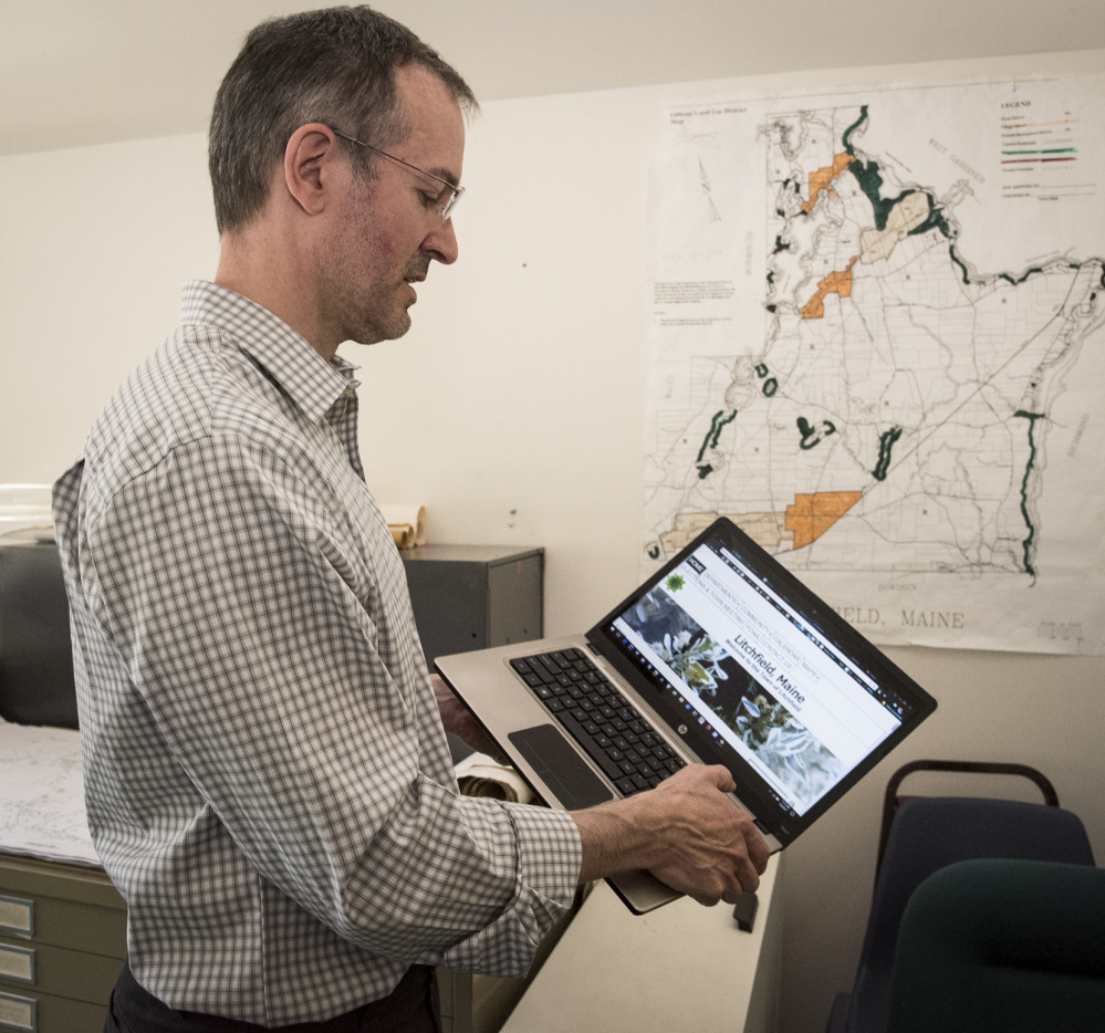 Kelly Weissenfels, web technician for the town of Litchfield, toggles through its website. Weissenfels is planning to make improvements to the outdated website, such as instructions for car registration and applying for marriage licenses.