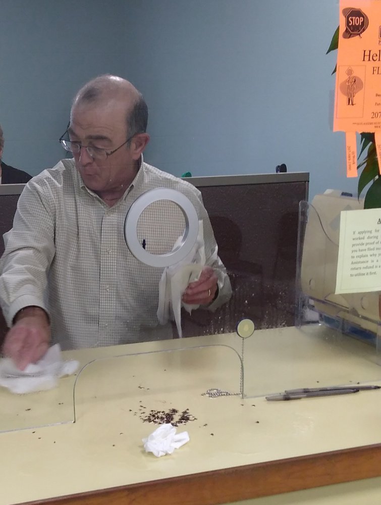 Ralph St. Pierre, Augusta's finance director and assistant city manager, picks up bedbugs that were reportedly spilled by a disgruntled man June 2 at Augusta City Center.