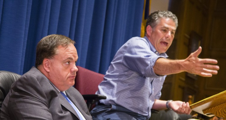 Portland City Manager Jon Jennings listens as Mayor Ethan Strimling speaks during a workshop Monday night seeking to mediate an ongoing dispute between the two.