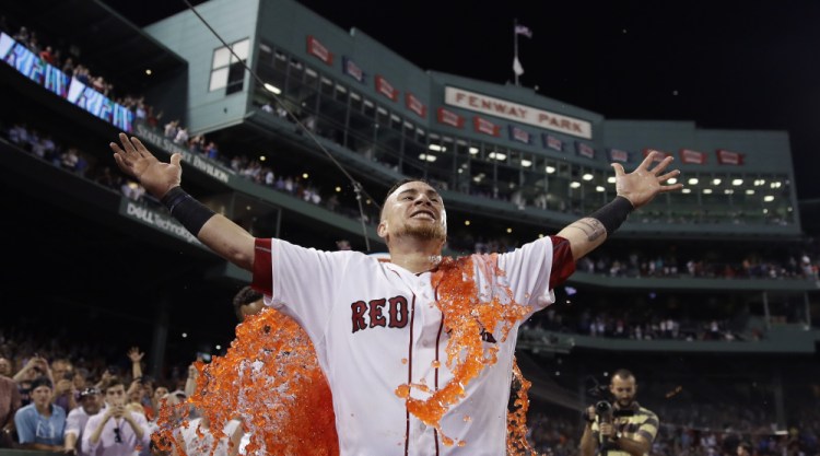 The Red Sox's Christian Vazquez is doused after his three-run homer in the bottom of the ninth against the Cleveland Indians on Tuesday at Fenway Park.