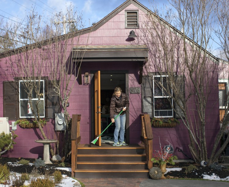 Krista Desjarlais sweeps the steps at the Purple House in North Yarmouth last fall. It was named one of 50 finalists for Bon Appetit's "Best New Restaurants in America."