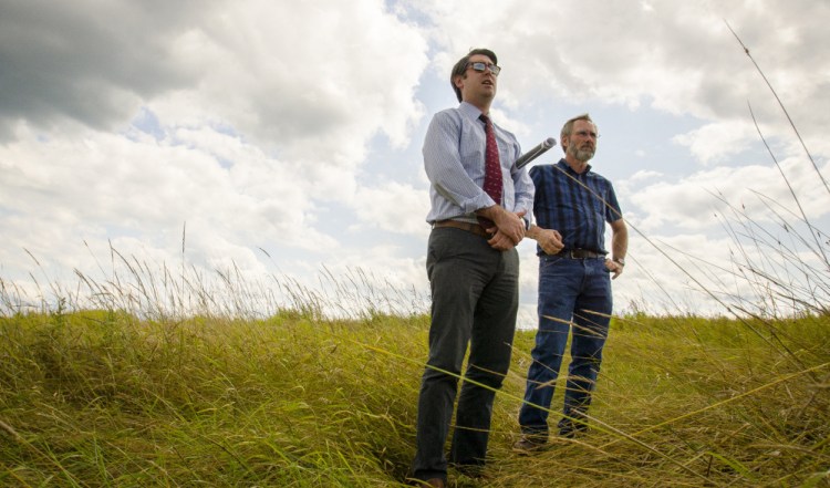 Garvan Donegan, a Central Maine Growth Council economic development specialist, left, and Greg Brown, Waterville city engineer, survey a landfill off Webb Road. The city plans to use the site for a solar array that could power 3,750 homes.