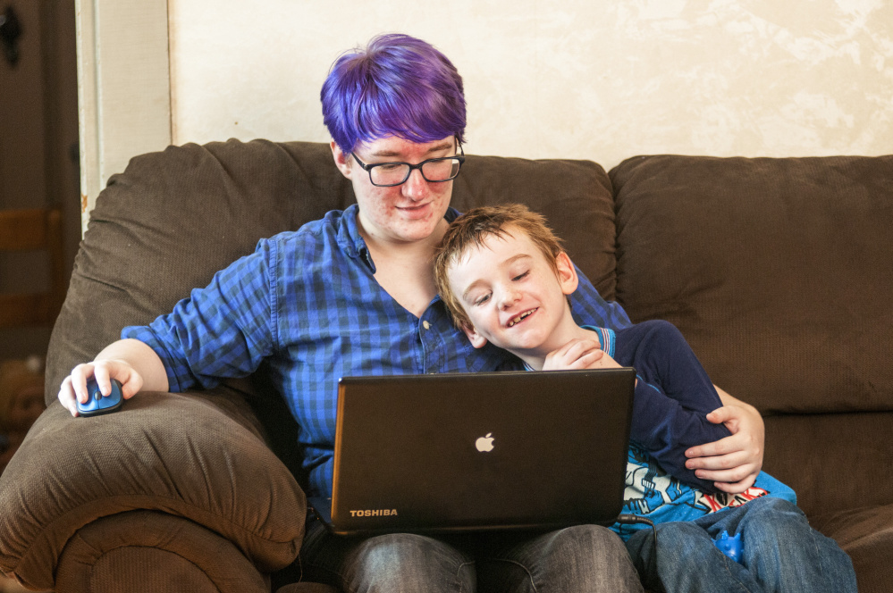 Abigail Hughes, left, plays a computer game with her brother, Sebastian Hughes, on Tuesday at the family's Winthrop home.