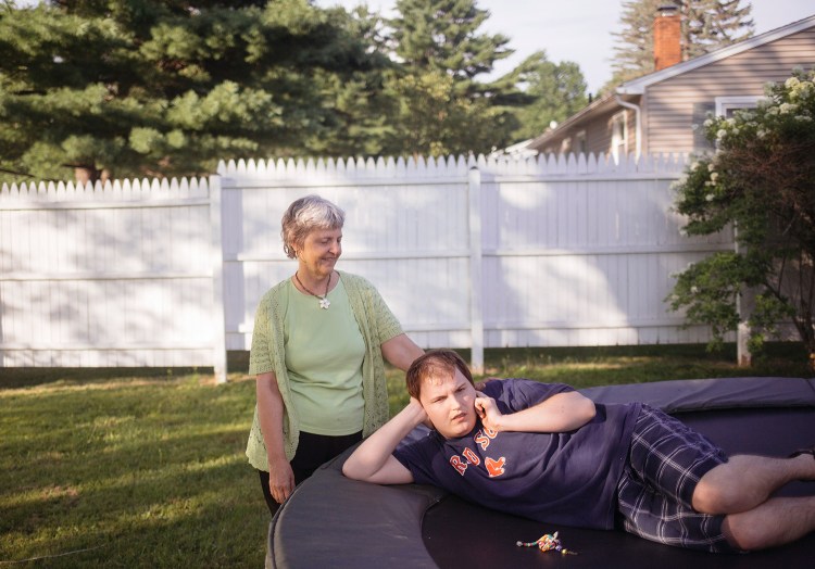 Kim Humphrey and her son Daniel Humphrey pose on the trampoline that Daniel loves in the backyard of the group home in Lewiston where he lives. Daniel, 28, has severe autism and is nonverbal. He needs round-the-clock care and has lived in John F. Murphy homes since 2009. His mother said it has been nothing but a positive experience, so when she heard about mistreatment of developmentally disabled patients in Maine, she was horrified. Humphrey said the thought of someone mistreating someone as vulnerable as her son keeps her awake at night.