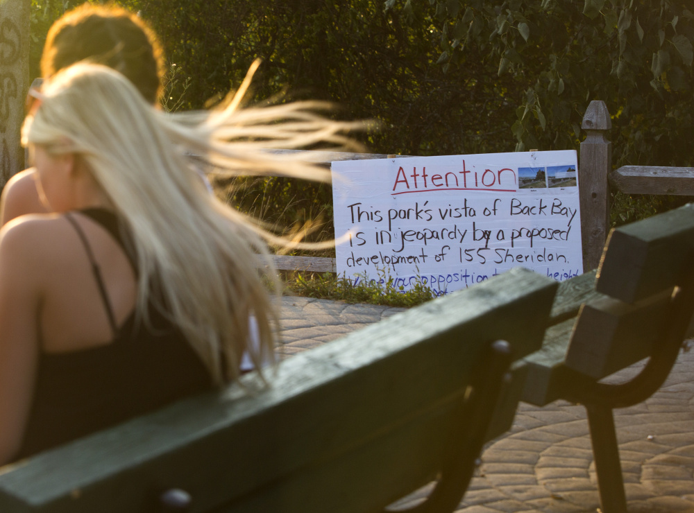 PORTLAND, ME - AUGUST 11: One of the best views in Portland at Sumner Park on Munjoy Hill may be compromised by a proposed, six-story condominium building. A sign informs visitors of the proposed develpment as they enjoy the sunset on Thursday. (Photo by Derek Davis/Staff Photographer)