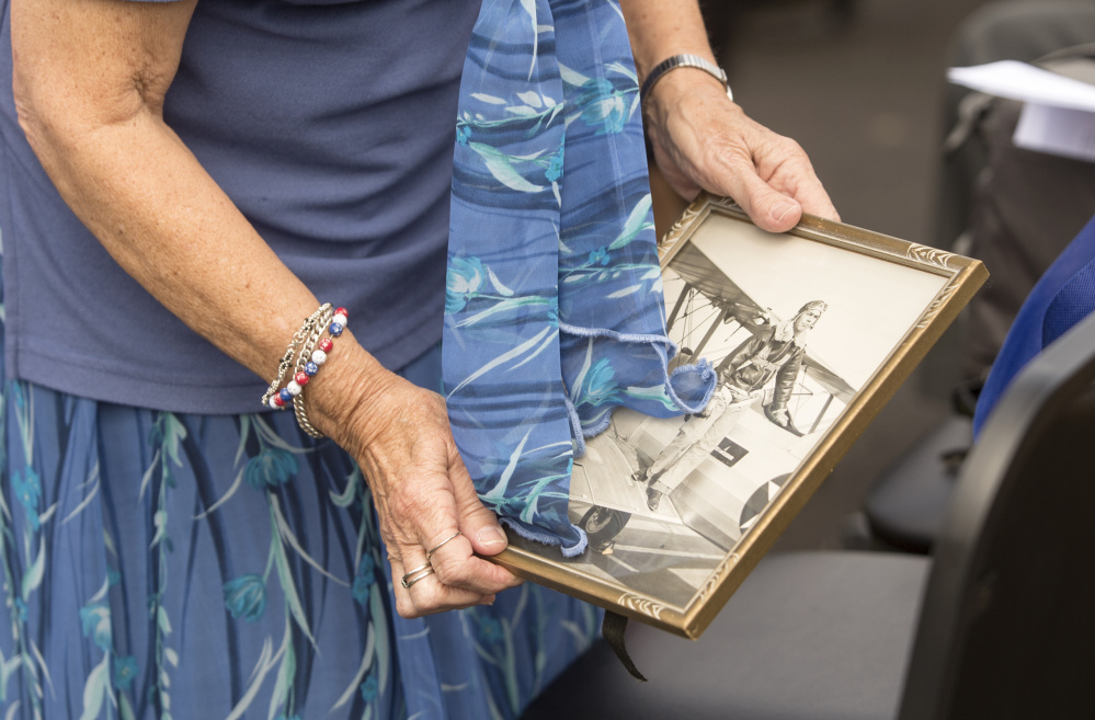 Norma Spurling holds a framed picture of her brother George Hout on Friday during the ceremony in Winslow.