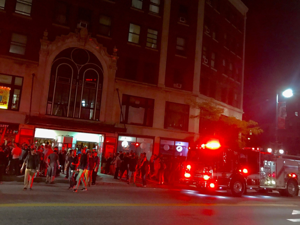 Portland firefighters respond to a smoke alarm set off Tuesday night at the State Theatre during a performance by the Pixies.