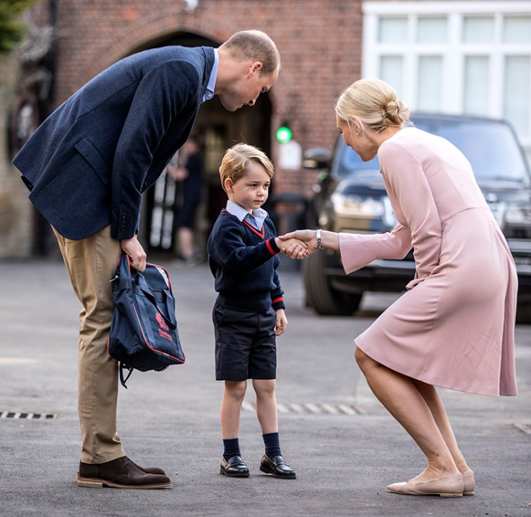 Prince William accompanies Prince George as he is greeted by the head of the lower school as he arrives for his first day of school in  London on Thursday.