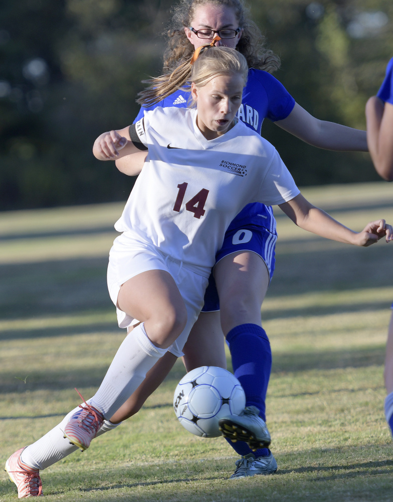 Caitlin Kendrick of Richmond attempts  to keep possession Monday as Megan Niedzwiecki of Old Orchard Beach knocks the ball away during their game at Richmond. The teams finished in a scoreless tie.