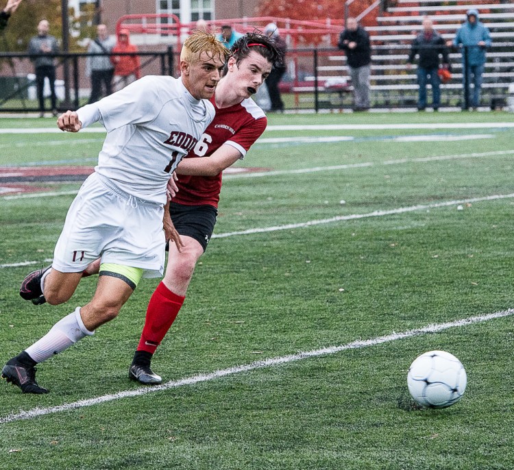 Alex Thompson, left, of Edward Little and Quinn Brown of Camden Hills wrestle with each other as they pursue the ball during a Class A North quarterfinal Thursday afternoon at Bates College. Edward Little won, 1-0.