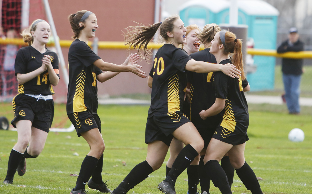 Cape Elizabeth teammates rush to greet Prezli Piscopo (10) on her second goal of the first half during a Class B South girls' soccer semifinal on Tuesday at Greely High. Piscopo went on to score the game-winner in the second half of the Capers' 3-2 victory. (Staff photo by Jill Brady/Staff Photographer)