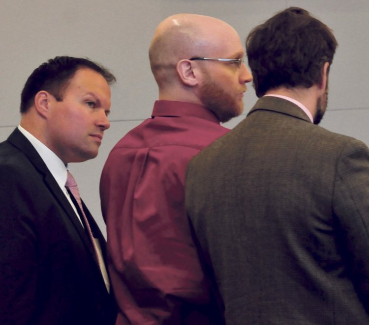 Robert Burton, center, listens to the guilty verdicts being read alongside his attorneys, Zachary Brandmeir, left, and Hunter Tzovarras, at Penobscot Judicial Center in Bangor on Thursday.