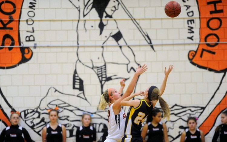 The Skowhegan Area High School "Indians" mascot is emblazoned on the wall of the gymnasium during a basketball game in December 2013.