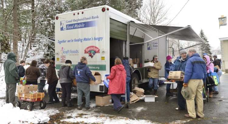 A line forms around the mobile food truck behind the Grace Episcopal Church in Bath in 2013. Economic hardship is hitting the middle class.