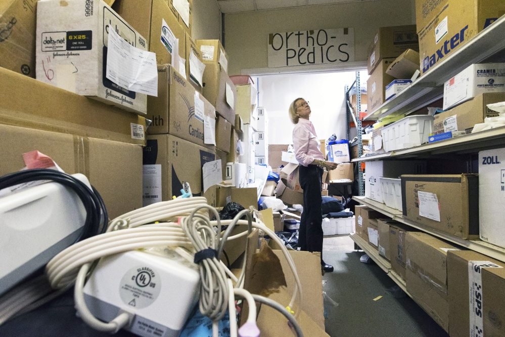 Elizabeth McLellan, founder of Partners for World Health, searches warehouse shelves for  boxes of orthopedic supplies to be shipped to Puerto Rico. She said the missions have grown to five or six year, with teams going to Tanzania, Libya, Peru, Uganda and Cameroon.