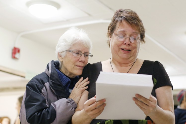 Tirrell Kimball, left, of Falmouth hugs Alyson McLaughlin as she reads memories of her brother, Doug "Digs" McLaughlin, written by Kimball's son, Stephen, who grew up with Doug. 