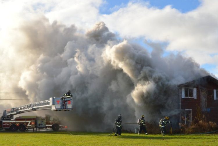 Heavy smoke, wind driven, hampered visibility as local fire departments battle a house fire at 167 Morrison Hill Road in Farmington on Friday morning.