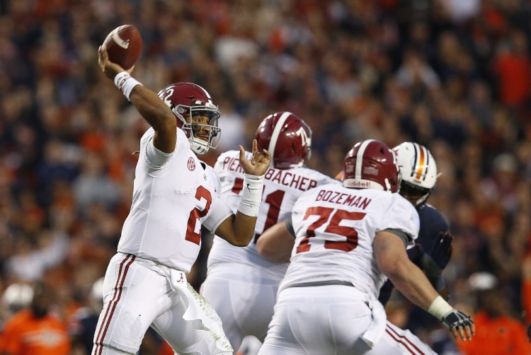 Alabama quarterback Jalen Hurts throws the ball during the second half of the Iron Bowl in Auburn, Ala. Despite losing to Auburn — which lost to Georgia in the SEC title game — the Crimson Tide were selected for the NCAA football playoff.