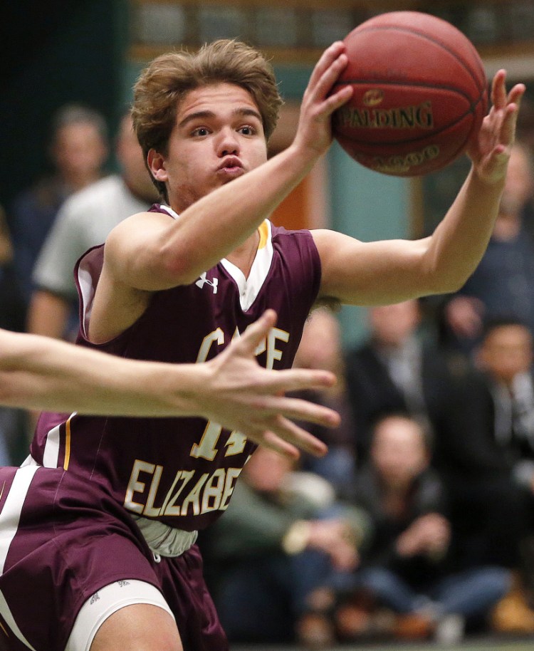 David Hare of Cape Elizabeth passes to a teammate while getting pressured by Waynflete players during Wednesday's game in Portland. Hare finished with six points and also played a key defensive role for the Capers.