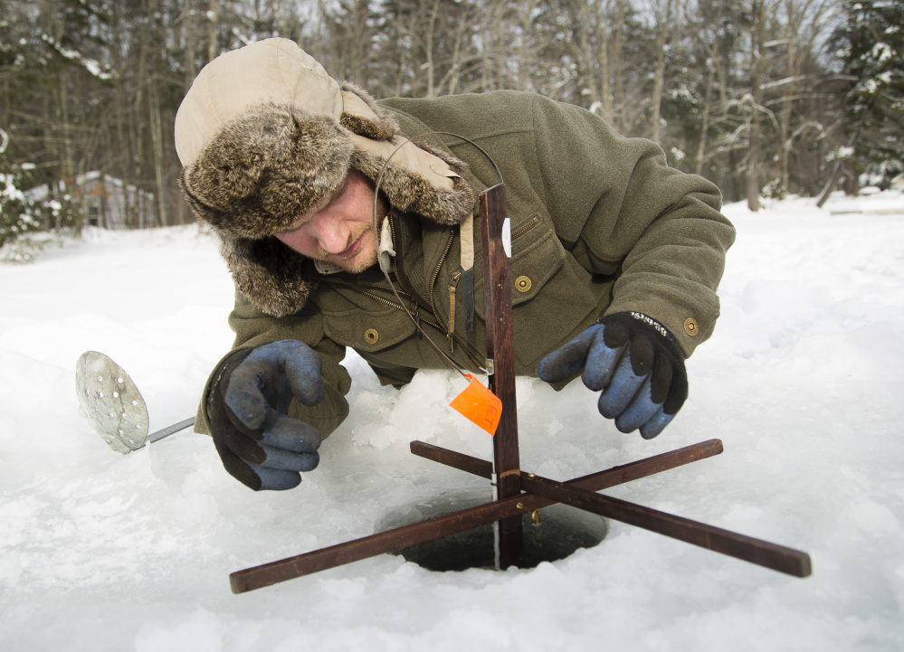 Jeremy Tarbox makes sure the the trap is properly set.