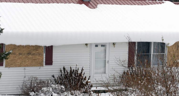 The boarded up windows at 543 Prescott Road in Manchester are seen Monday. On Saturday police discovered the remains of Clyde Shue, 82, and Kimberly Shue, 62, who died in an apparent murder-suicide at the residence.