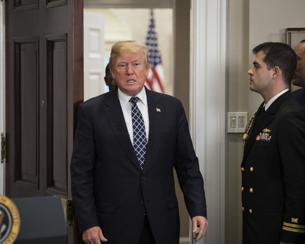 President Trump, shown Friday before signing a proclamation to honor Martin Luther King Jr. Day, acknowledged on Twitter using "tough" language during a meeting on immigration.