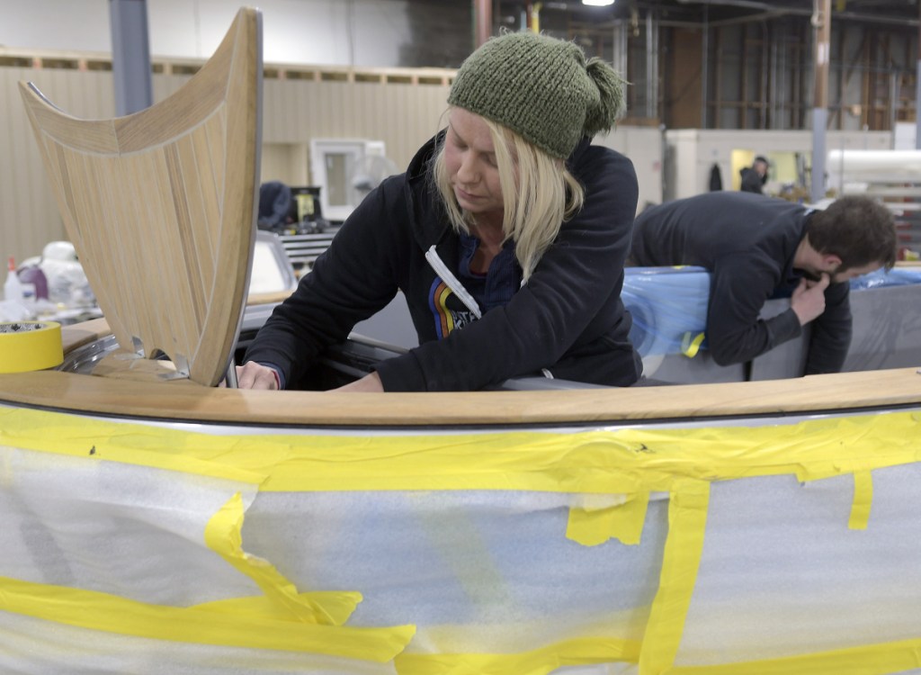 Molly Edwards and Aaron Arsenault work on a Carbon Craft tender at Southport Boats in Gardiner on Monday. Formerly part of Augusta's Kenway Corp., Southport has relocated to Gardiner under new ownership and will continue to produce its line of powerboats there.