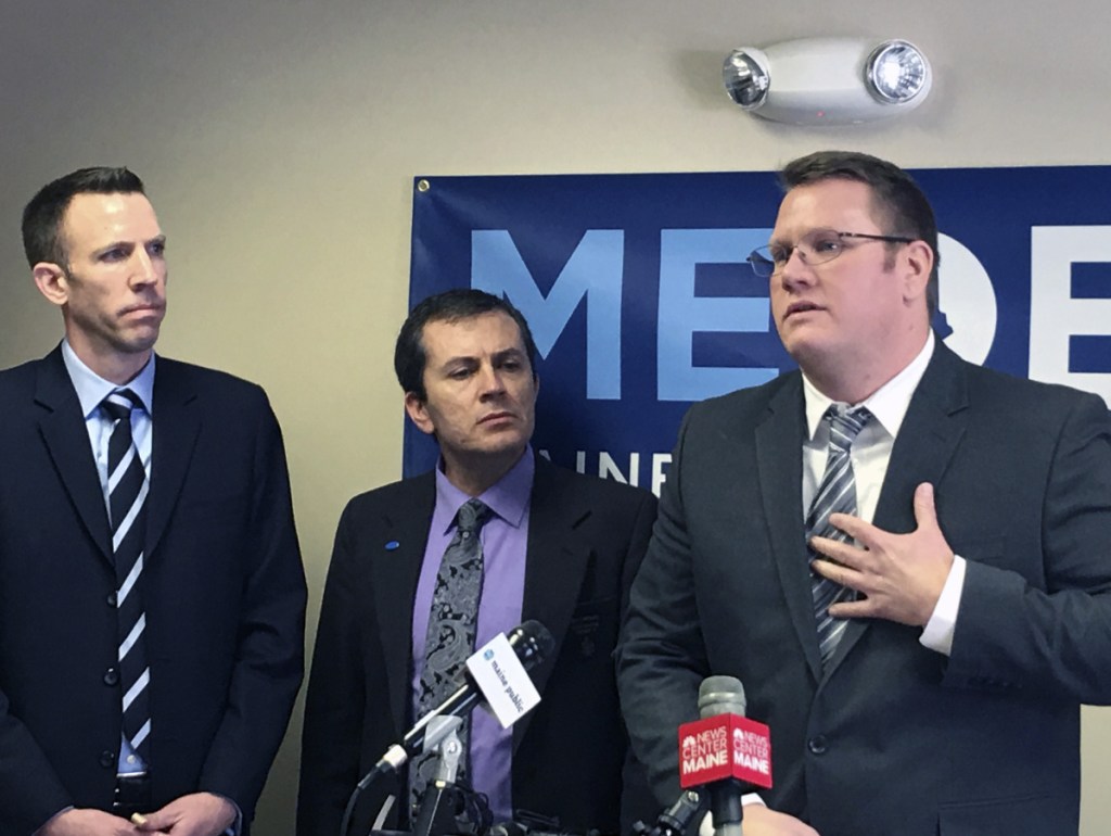 Phil Bartlett, left, chair of the Maine Democratic Party, and state Sen. Ben Chipman, D-Portland, listen Thursday as Andrew Kiezulas discusses how addicts in recovery can reclaim their life.