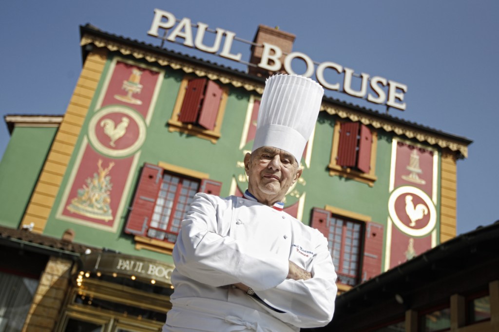 Paul Bocuse poses outside his famed Michelin three-star restaurant L'Auberge du Pont de Collonges in Collonges-au-Mont-d'or, central France.