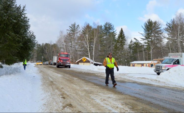 Members of the Temple Fire Department stop traffic Tuesday morning on Route 43 while state police investigate the discovery of the bodies of a husband and wife.