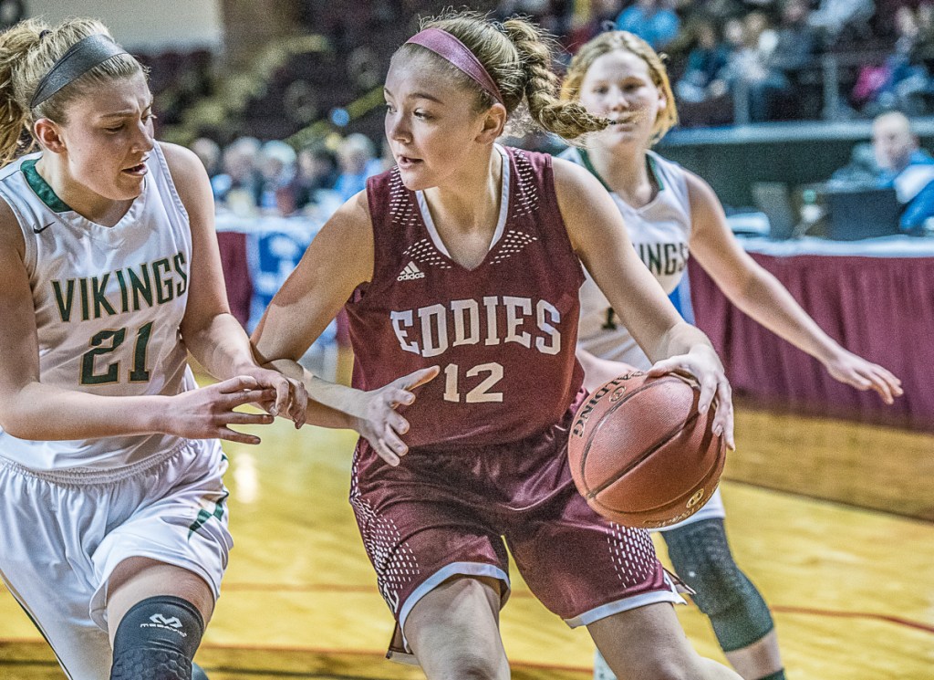 Edward Little's Jade Perry pushes past Oxford Hills' Maighread Laliberte during the Class AA North girls' basketball final at Cross Insurance Arena on Friday. (Andree Kehn/Sun Journal)