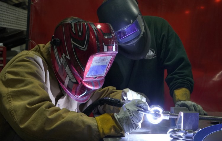 Sam Roy, 17, welds at DeepWater Buoyancy under the watchful eye of Joe Woods, a welder-fabricator at the maker of subsea buoyancy products. "Something just clicked" when he took a welding class, said Roy, adding: "I found it more interesting than anything I'd done before."