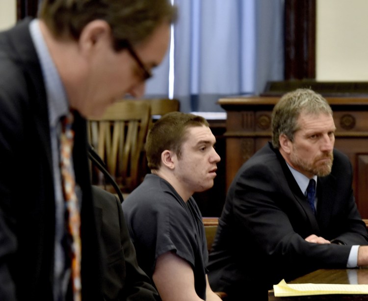 Assistant Attorney General Bud Ellis, left, reads evidence that would have been presented against defendant Jeremy Erving, center, during a hearing in which Erving changed his plea to guilty in the death of his uncle Randy Erving, in Somerset Superior Court. 