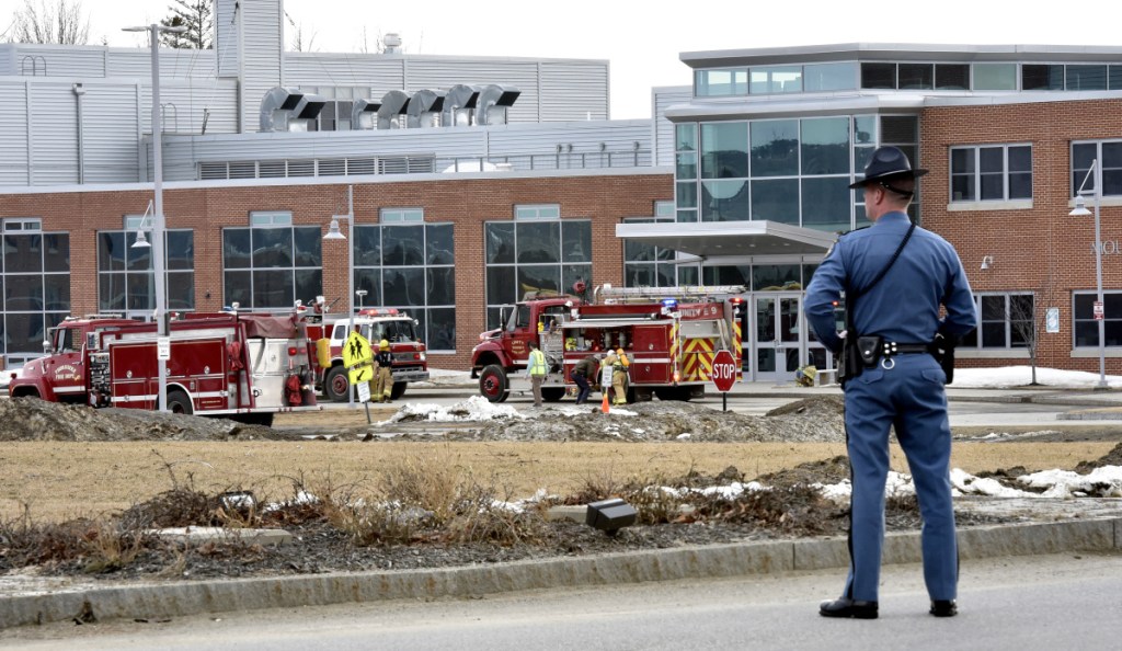 A state trooper blocks the entrance to the Mount View school complex in Thorndike as firefighters respond to a report of a chemical release Wednesday. About 750 students, along with the school staff, evacuated the buildings. Apparently a student released pepper spray in a classroom, affecting about 20 students.