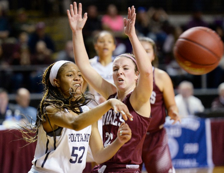 Amanda Kabantu of Portland passes off the ball as Edward Little's Piper Norcross moves in on defense in the Class AA semifinal game on Wednesday, February 21, 2018. Staff photo by Shawn Patrick Ouellette