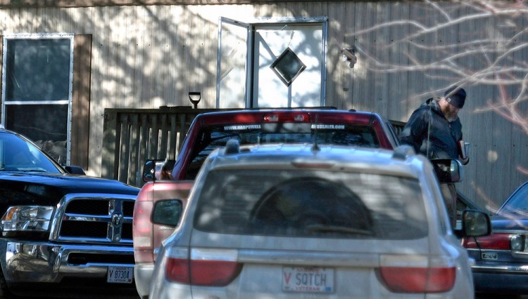 Maine State Police investigators examine the scene of the home at 946 Post Road in Bowdoinham, where police say 55-year-old Beulah "Marie" Sylvester was found with severe injuries Monday morning. She later died at Maine Medical Center.