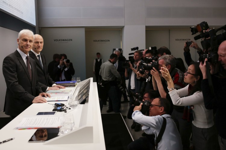 VW group CEO Matthias Mueller, left, and CFO Frank Witter, second from left, arrive for the annual media conference of the Volkswagen group, in Berlin, Germany, on Tuesday. Mueller said the automaker is committed to reducing diesel emissions and has eliminated 160,000 older diesels model from the road through trade-in incentives.