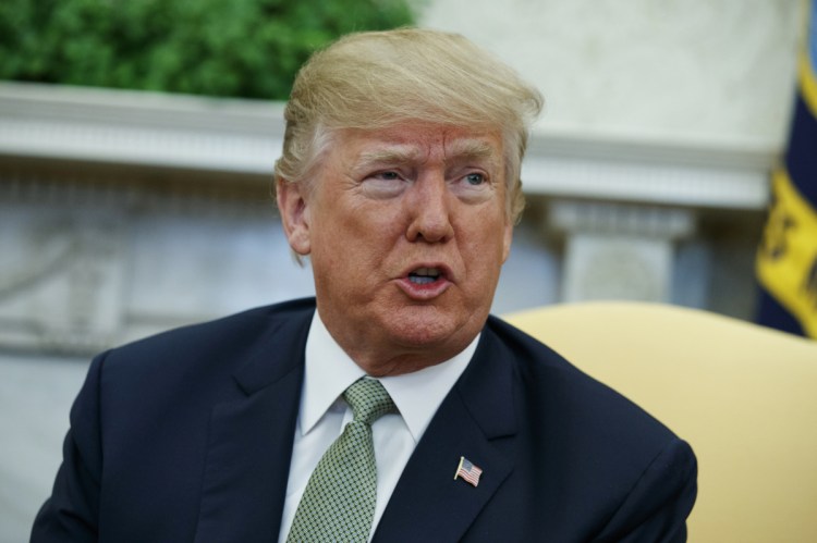 President Trump talks with reporters during a meeting in the Oval Office of the White House in Washington. Trump is questioning the impartiality of Robert Mueller's investigation and says the probe is groundless, while raising doubts about whether a fired top FBI official kept personal memos outlining his interactions with Trump.