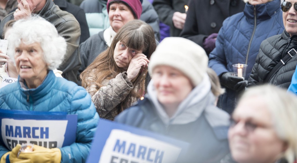 Mary LaFountaine wipes away tears Saturday at Castonguay Square in Waterville.