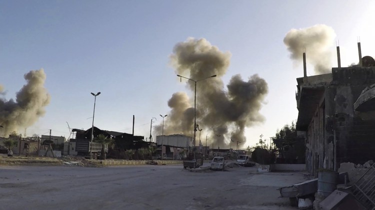 This photo released by the Syrian Civil Defense White Helmets, which has been authenticated based on its contents and other AP reporting, shows smoke rising after Syrian government airstrikes hit in the town of Douma, in eastern Ghouta region east of Damascus, Syria, on Saturday. Syrian opposition activists and paramedics said at least 40 people were killed in last weekend's suspected chemical attack and blamed the government.