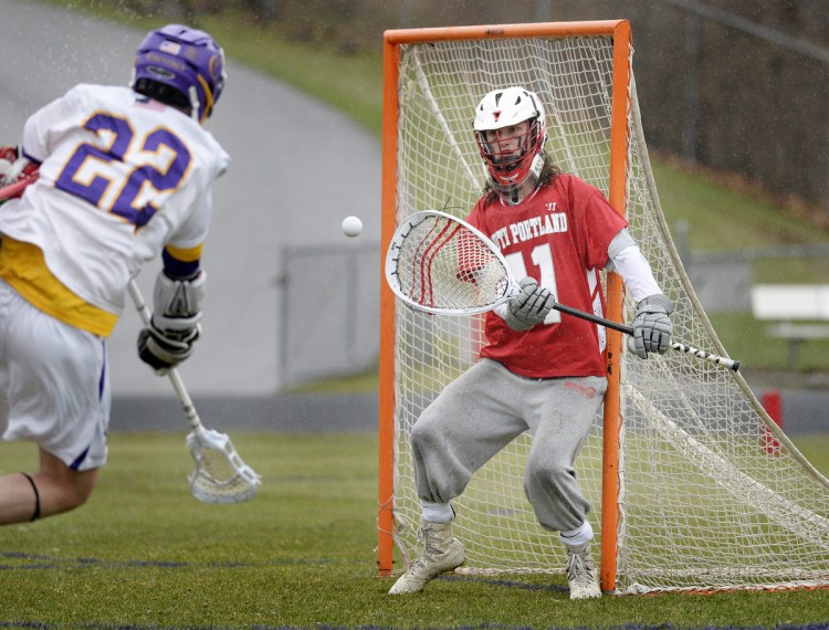 South Portland goalie Quinn Watson is in position to stop a shot by Chris St. John of Cheverus. Watson finished with 10 saves, and St. John scored once.