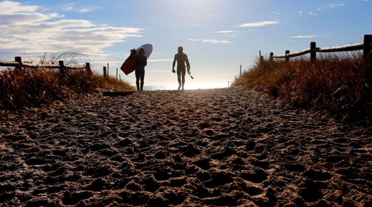 Stephan Laufer and Ryan McDermott of Scarborough walk toward the water to take advantage of waves at Scarborough Beach in November 2015.