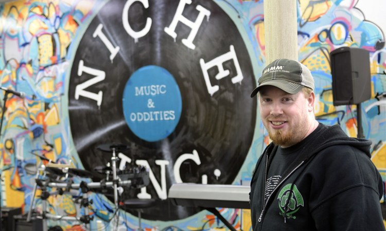 Jason Goucher stands in his Gardiner shop, Niche Inc, on Thursday. The business will be hosting some of Les Paul's guitars during the community's upcoming music walk.