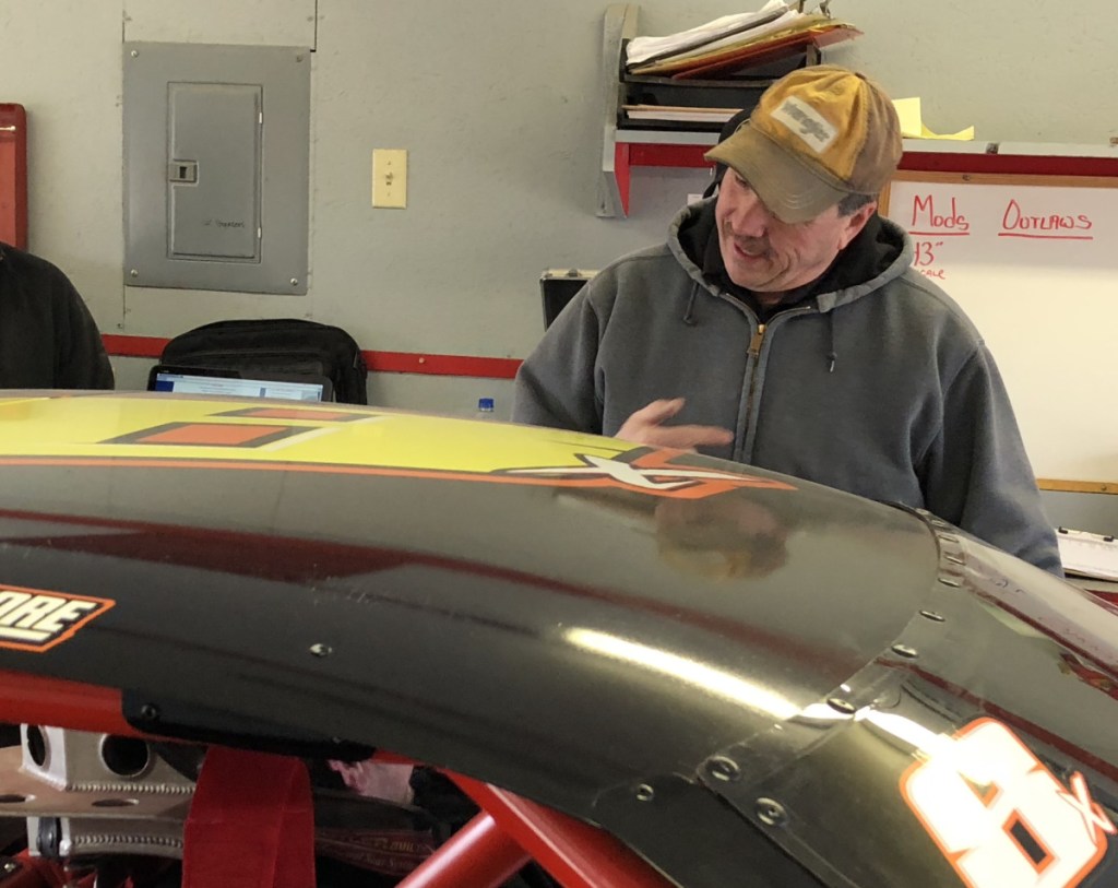 Dave Brannon of Lisbon talks to a driver during technical inspection following a qualifying race last Saturday night at Wiscasset Speedway in Wiscasset.