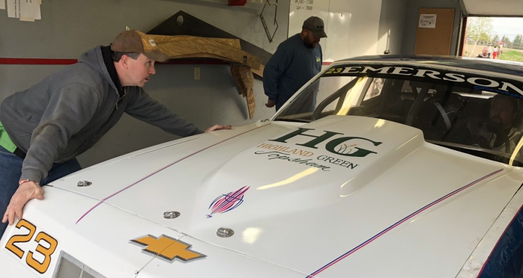 Wiscasset Speedway technical director Dave Brannon helps position a car on scales following a qualifying race last Saturday night at the track. Brannon was named to the position prior to the season.