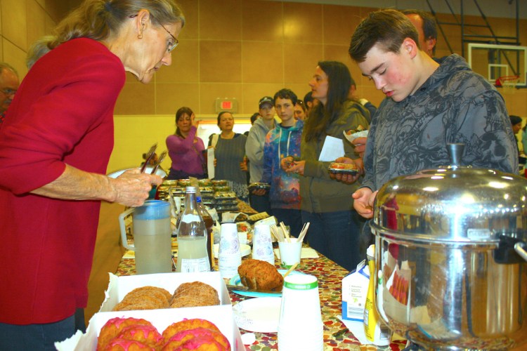 People line up for vegan doughnuts and coffee at the 2017 Veg Fest in Portland. This year's event takes place June 2 at the East End Community School.