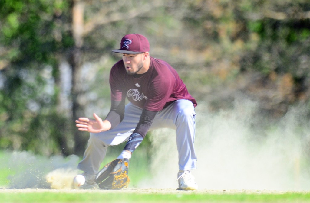 Richmond shortstop Matt Rines fields a ball in the dust during Friday's Class D South semifinal against Greenville.