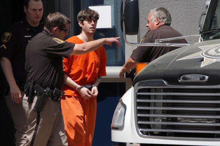 John D. Williams, who is accused of killing Somerset County sheriff's Cpl. Eugene Cole, is led out of the Cumberland County Courthouse on June 12 after pleading not guilty to murder.