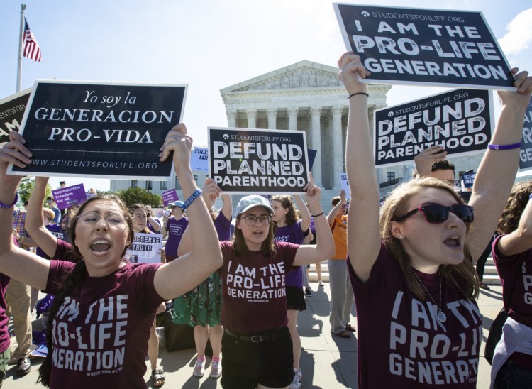 Demonstrators in front of the Supreme Court early Monday.